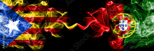 Catalonia vs Portugal  Portuguese smoke flags placed side by side. Thick colored silky smoke flags of Catalonia and Portugal  Portuguese