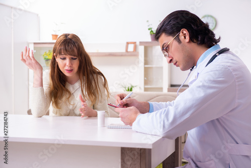 Young female patient discussing with male psychologist personal 