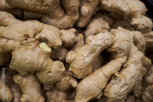 Heap of dried ginger root background, close-up. Healthy diet food