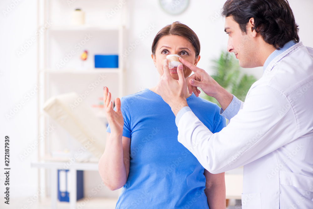 Woman visiting male doctor for plastic surgery Woman visiting male doctor for plastic surgery