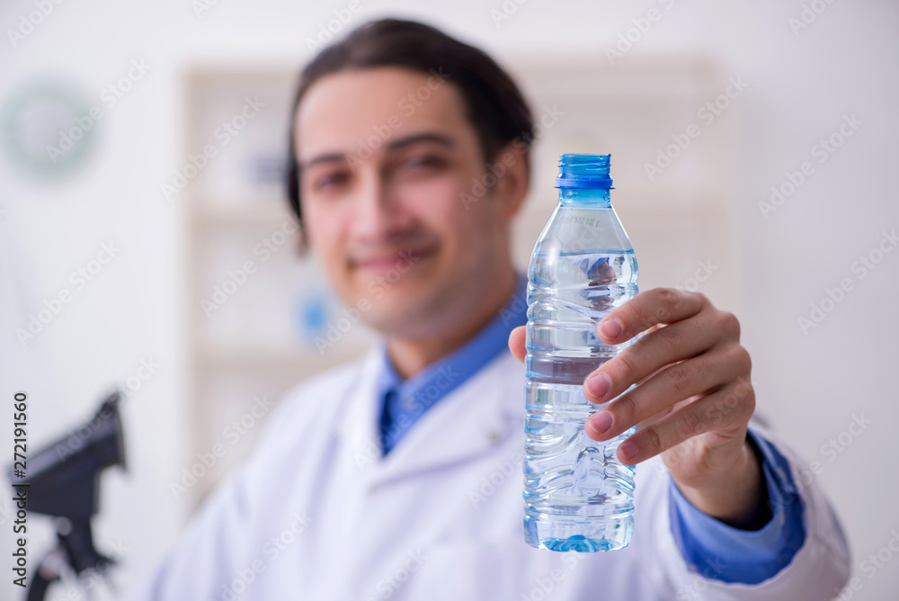 Young male chemist experimenting in lab Young male chemist experimenting in lab