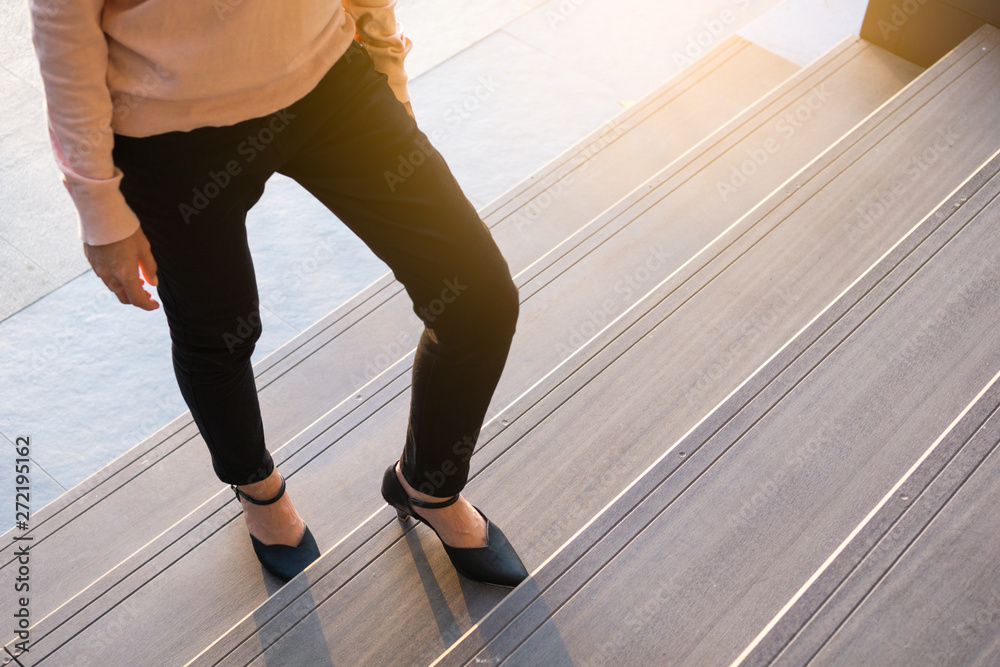 Business woman up the stairs. Female legs in high heels shoes walking on the stairs. Business woman up the stairs. Female legs in high heels shoes walking on the stairs.