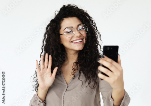 lifestyle, technology and people concept - young african woman taking selfie with smartphone