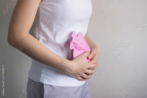 Close up woman has abdominal pain, woman's belly with hot water bottle,Close up woman use Hot Pack