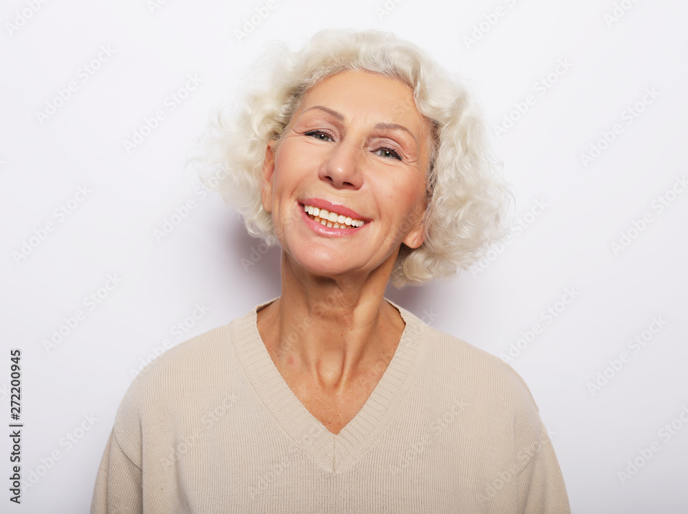 lifestyle, emotion and people concept: Close up portrait of happy senior woman smiling