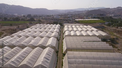 Flying above farming agricultural tents in south Israel kibbutz 4k aerial
