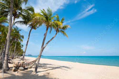 hammock hang on palm tree. Landscape of summer season in tropical beach.
