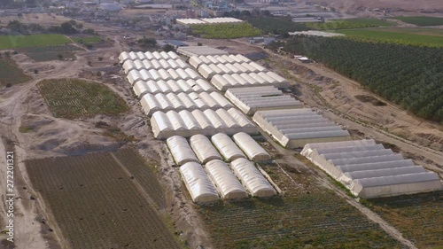 Flying above farming agricultural tents in south Israel kibbutz 4k aerial