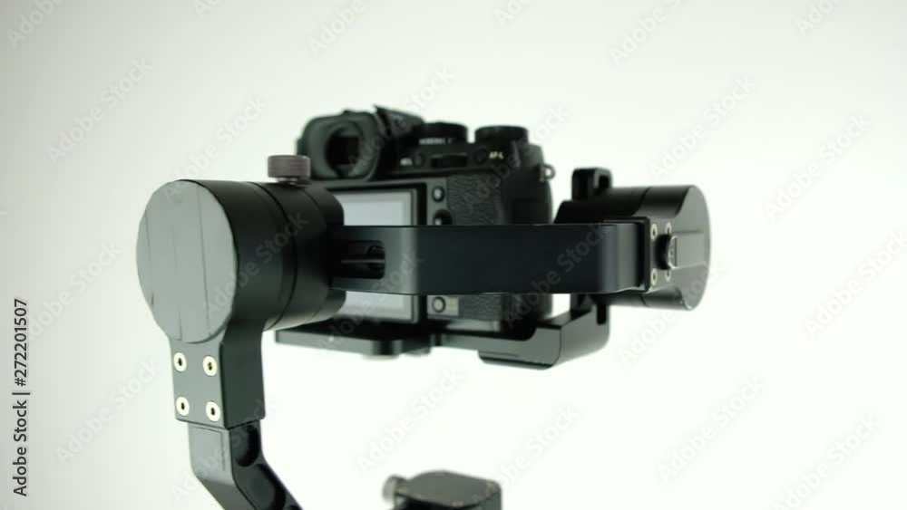 New innovative three-axis stabilizer with digital camera rotates on white background. 4k. Presentation. New innovative three-axis stabilizer with digital camera rotates on white background. 4k. Presentation.