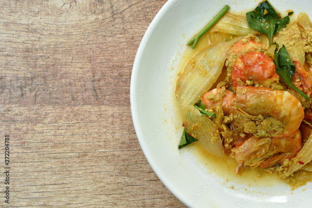 stir-fried shrimp with egg and yellow curry on dish stir-fried shrimp with egg and yellow curry on dish