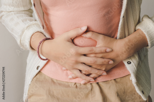 Young woman suffering from abdominal pain. Menstrual pain. photo