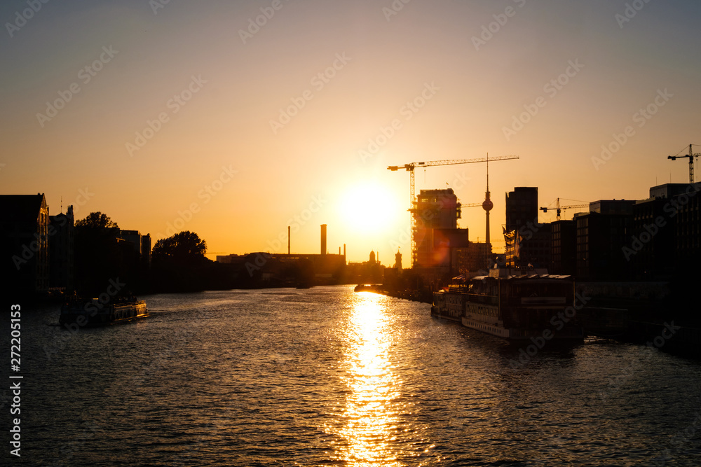 sunset sky over river spree in Berlin with Tv tower skyline -