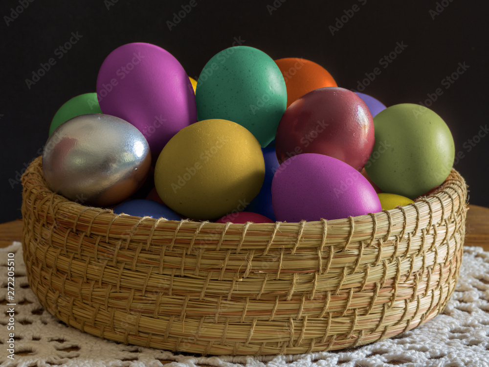 multi colored eggs in a wicker basket multi colored eggs in a wicker basket