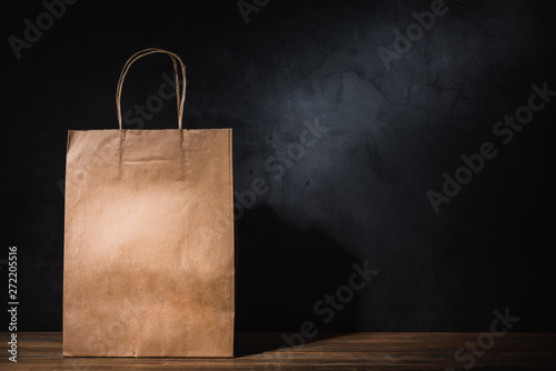 craft paper shopping bag on wooden table