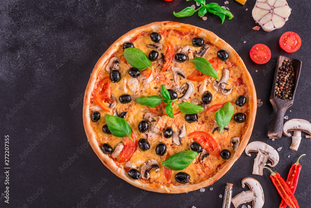 Tasty fresh hot pizza against a dark background. Pizza, food, vegetable, mushrooms.  It can be used as a background