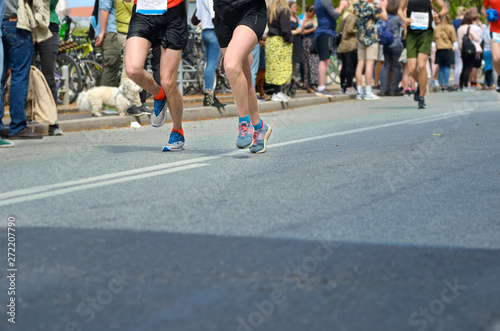 Marathon running race, many runners feet on road racing, sport competition, fitness and healthy lifestyle concept