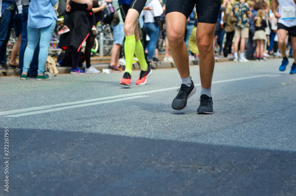 Marathon running race, many runners feet on road racing, sport competition, fitness and healthy lifestyle concept Marathon running race, many runners feet on road racing, sport competition, fitness and healthy lifestyle concept
