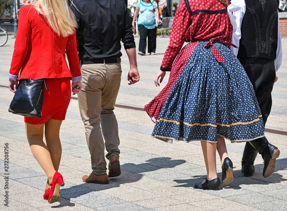 People on the street in regular and traditional clothing