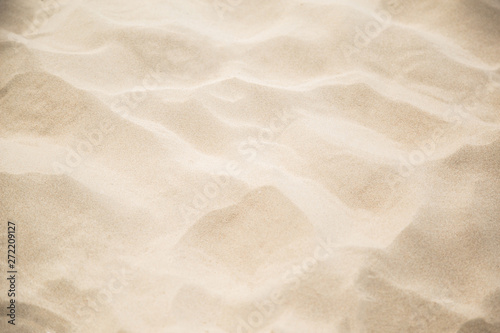 Fine beach sand in the summerBackground with copy space and visible sand texture.