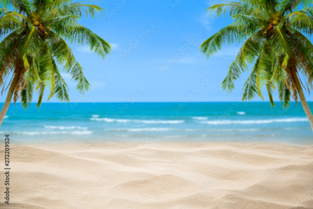 Fototapeta premium Beach with blurry blue ocean and sky,palm tree background ,Summer Concept .