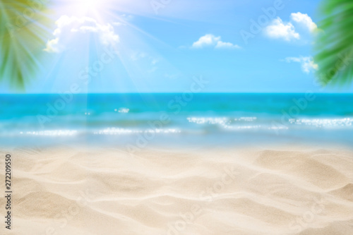 Beach with blurry blue ocean and sky palm tree background  Summer Concept .