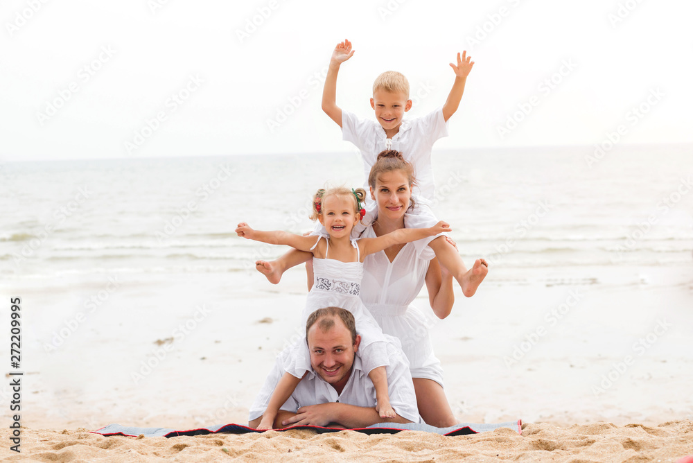 Happy young family on the sunset at the beach. Happy young family on the sunset at the beach.