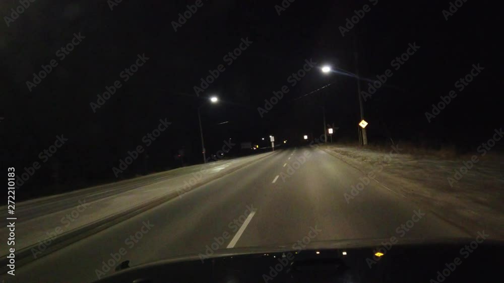Driving On Road At Night On Angle With Red Sports Car Driving By And Overhead Traffic Night Lights Driving On Road At Night On Angle With Red Sports Car Driving By And Overhead Traffic Night Lights
