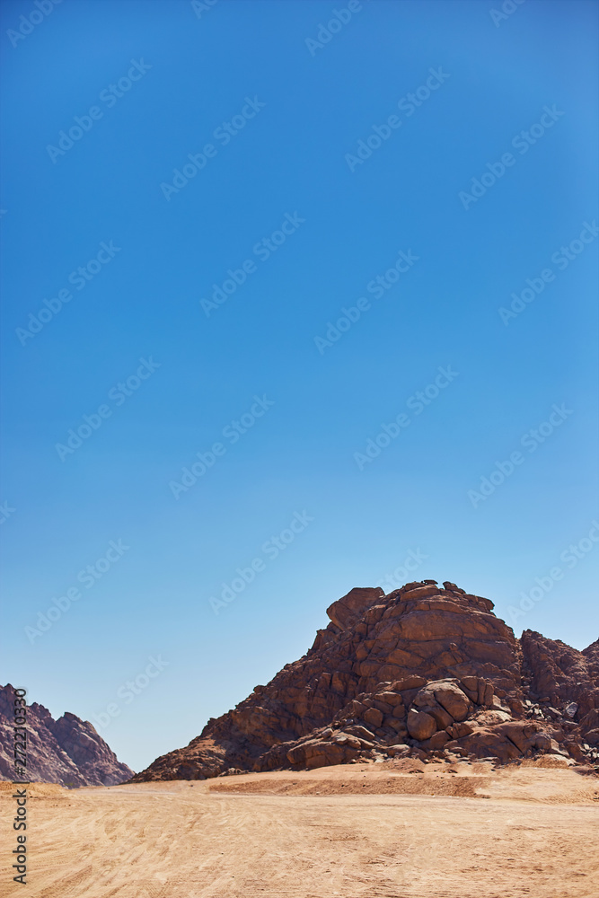 Desert on a background of mountains. Beautiful sand dunes in the desert. Copy space.