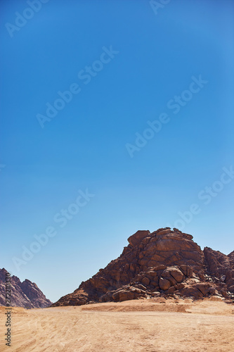 Desert on a background of mountains. Beautiful sand dunes in the desert. Copy space.