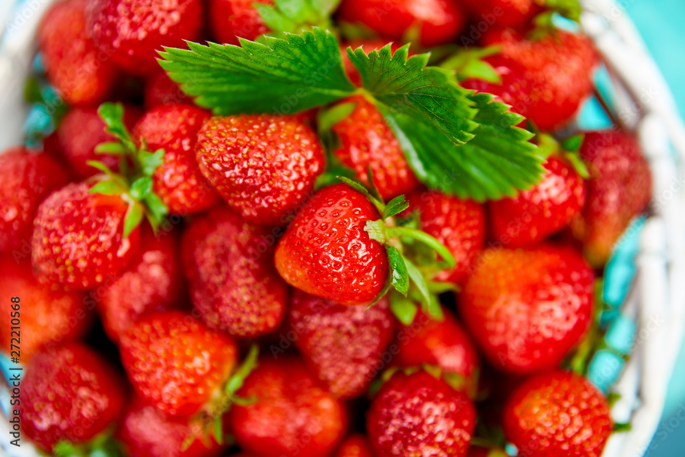 Ripe red strawberries on blue table, Strawberries in white basket. Fresh strawberries. Beautiful strawberries. Diet food. Healthy, vegan. Top view. Flat lay. Ripe red strawberries on blue table, Strawberries in white basket. Fresh strawberries. Beautiful strawberries. Diet food. Healthy, vegan. Top view. Flat lay.