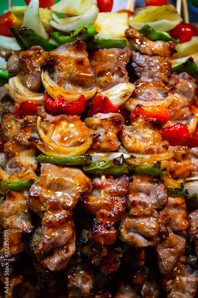  barbecue grill of pork skewers with tomatoes  onion and bell peppers