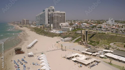 Herzliya beach with umbrellas, Israel, 4k aerial drone view photo