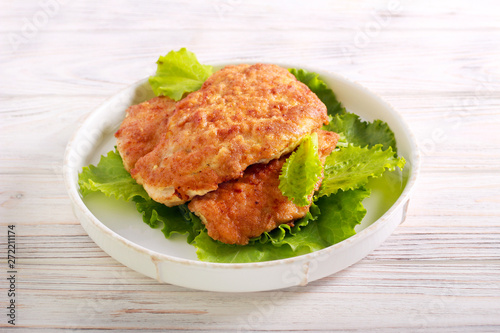 Chicken schnitzel over lettuce