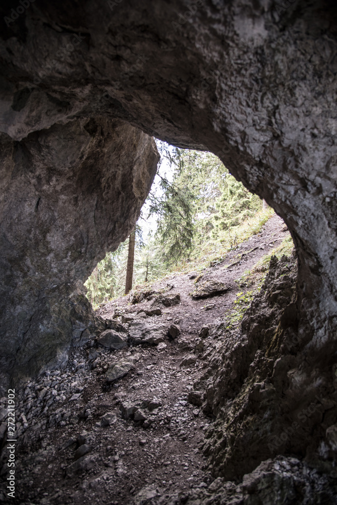 hiking trail through small cave bellow Poludnica hill in Nizke Tatry mountains in Slovakia