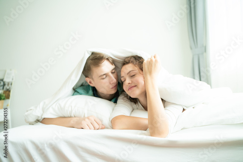 Beautiful loving couple relaxing on bed