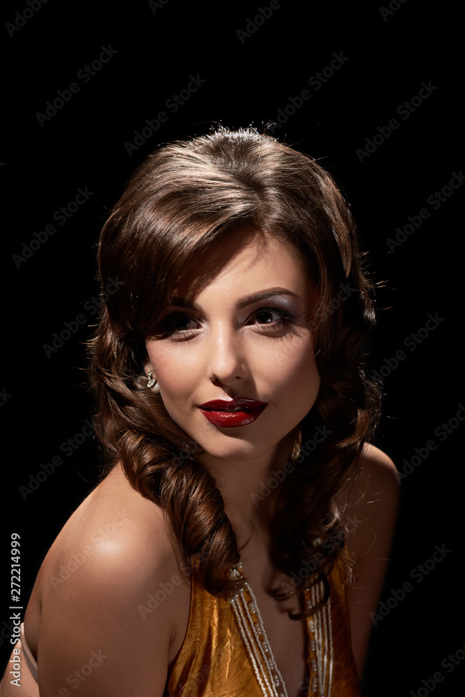 Beautiful glamour smiling woman posing on black background