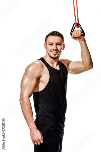 Portrait of happy handsome bodybuilder training with elastic expander