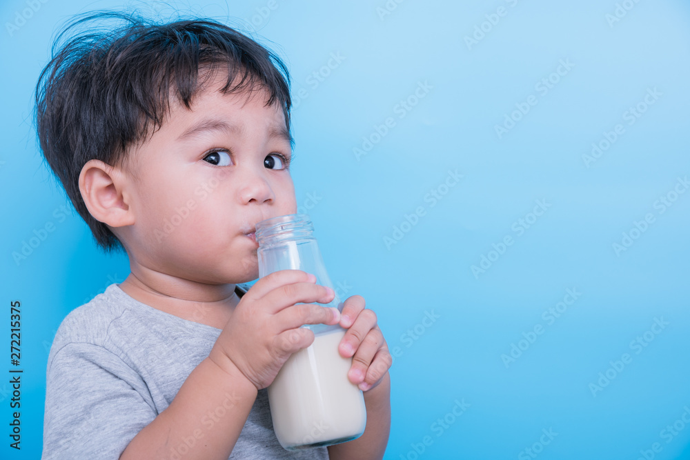 Asian little child boy about 2 year drinking milk from bottle glass itself Asian little child boy about 2 year drinking milk from bottle glass itself