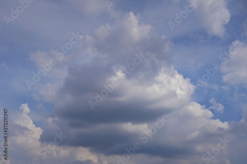 Blue sky with big shape cumulus cloud in the rainy day. Soft focus. Low key. Nature background concept.
