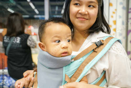 Mother hold baby boy shopping in supermarket