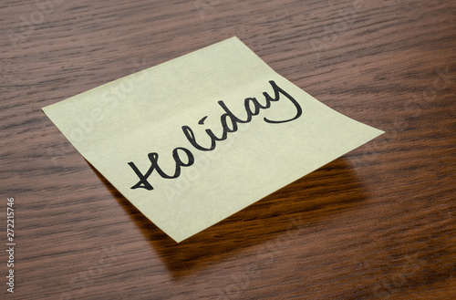 Sticky note with the text Holiday