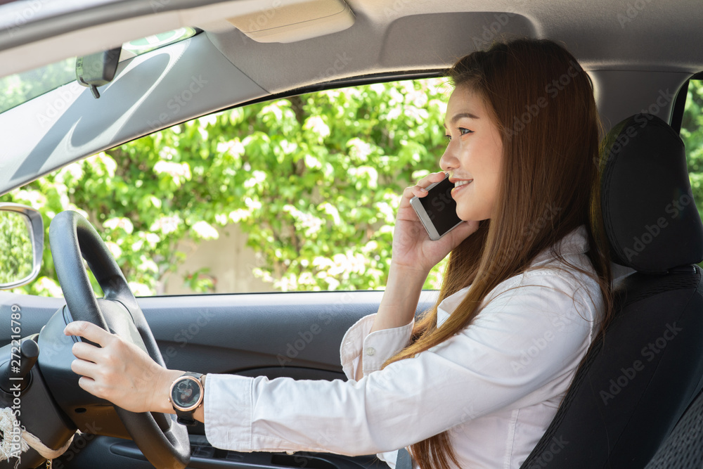 Beautiful attractive young woman smile in casual sitting in car talking in smartphone,Diving car with confident and happiness feeling,Happy transport concept Beautiful attractive young woman smile in casual sitting in car talking in smartphone,Diving car with confident and happiness feeling,Happy transport concept