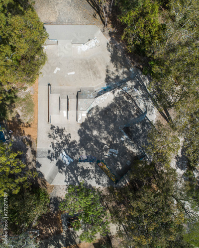 Skate park view fron the sky taken from a drone in the middle of a park with trees photo