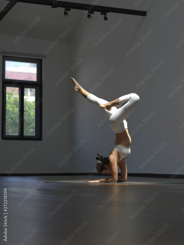 Asian chinese single woman in white practising Yoga