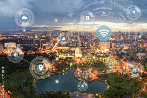 Smart city and wireless communication network concept. Digital network connection lines of Hanoi city at twilight period. Cau Giay park, west of Hanoi