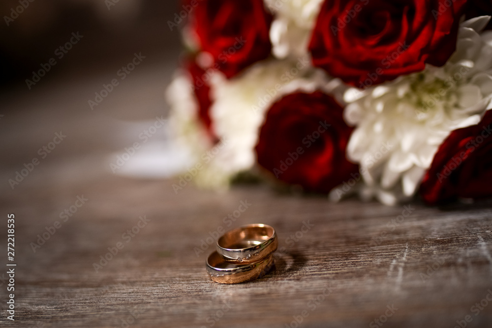 wedding rings and red roses