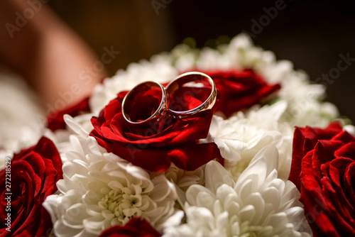wedding rings and red roses