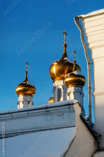 Behind the buildings of the Perm Holy Trinity Stefanov monastery are the towers of the altar part of the monastery. Winter. Lies snow. photo