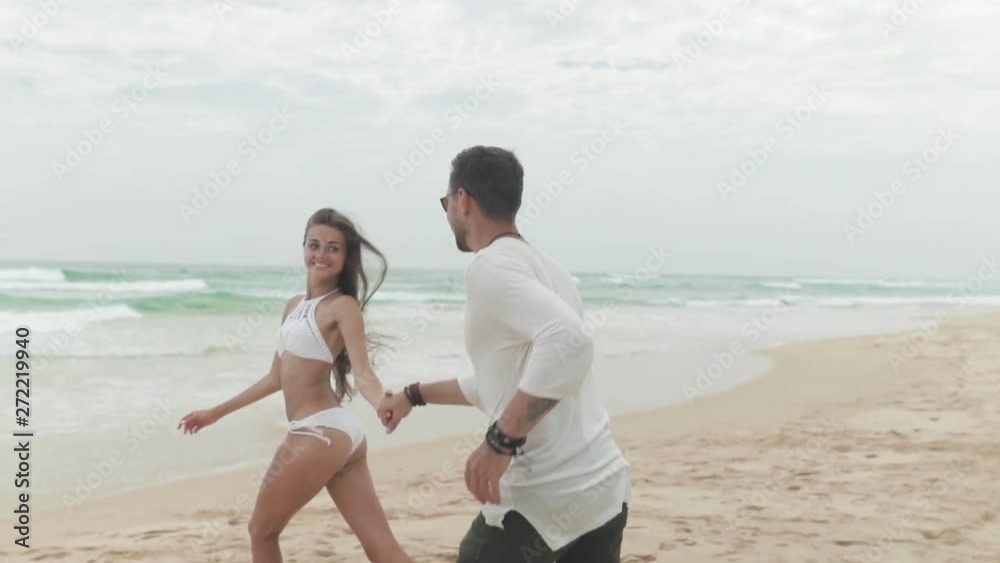Happy couple running to sea Happy couple running to sea