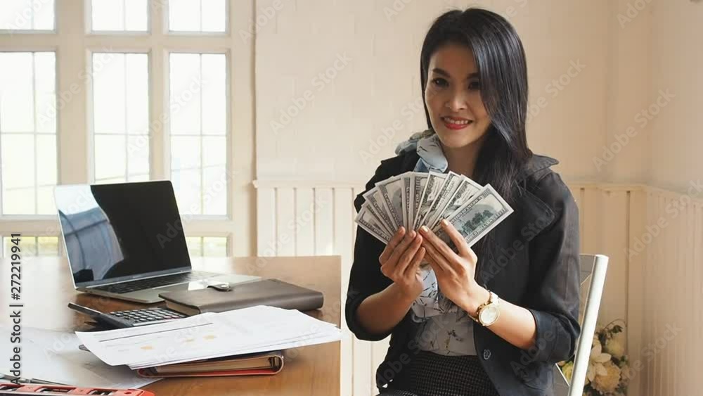 Beautiful Businesswoman throwing banknotes in the air she lucky and successful of her business. Beautiful Businesswoman throwing banknotes in the air she lucky and successful of her business.